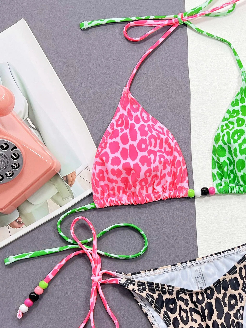 Women's leopard print bikini swimsuit set with bra and briefs on a white background.