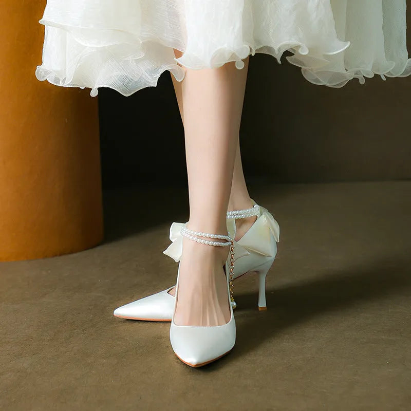 Stiletto pointed toe satin pumps with beaded pearl strap in Champagne colour