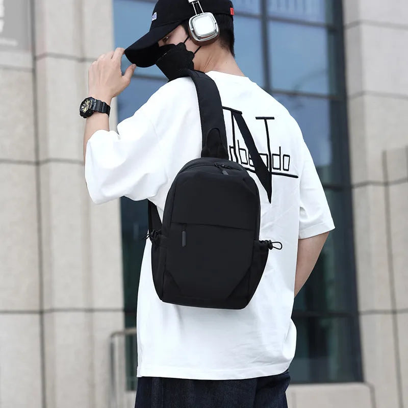 Grey mens chest bag showing shoulder strap and main compartment with waterproof exterior.
