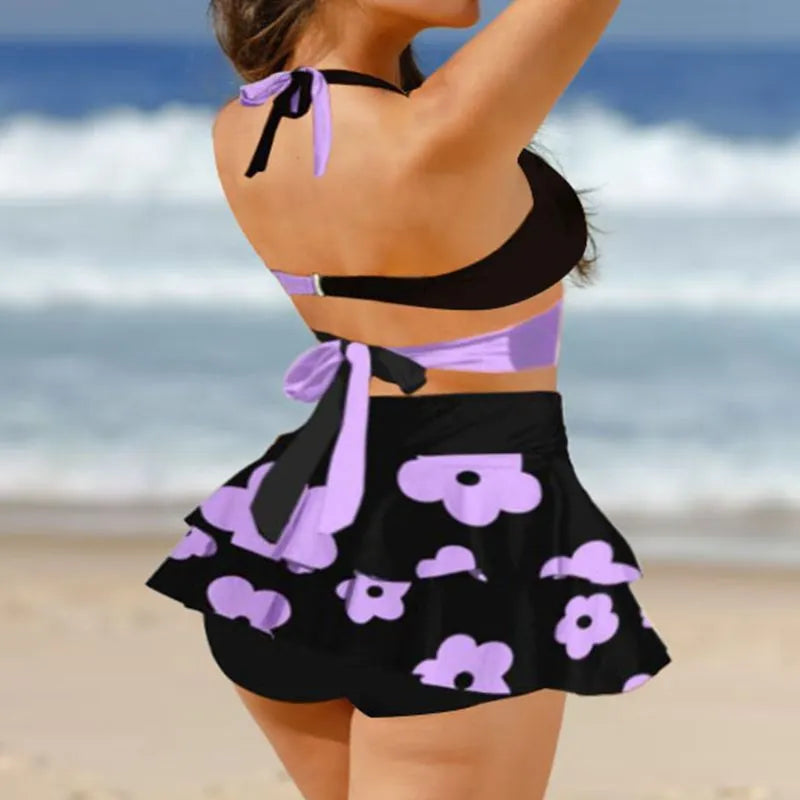 Purple women's high-waisted bikini set with matching skirt and lace-up detail