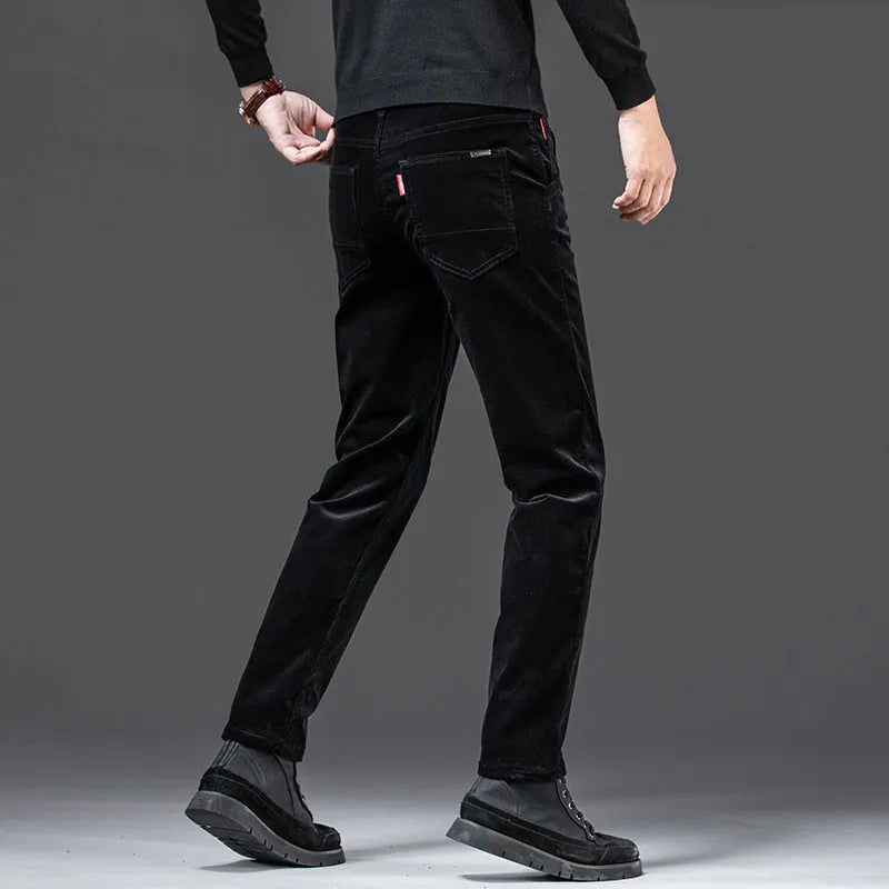 Men's straight slim-fit corduroy trousers in black, cotton fabric, side view on model