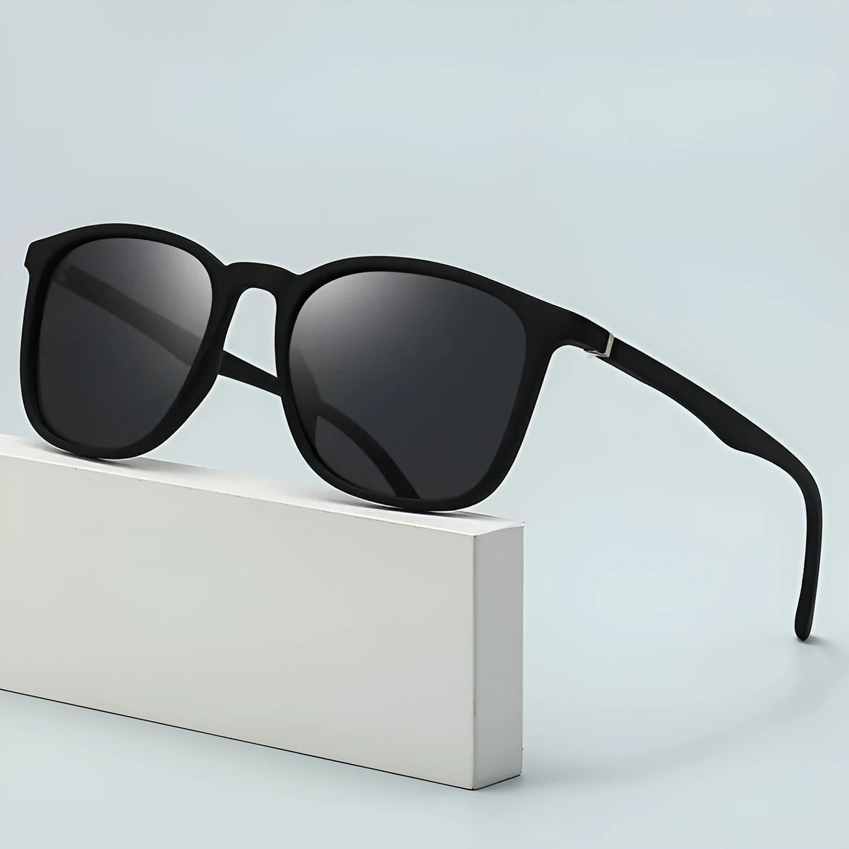 Men's polarised sunglasses with a black frame, dark green lenses, and an elastic grip spectacle foot.