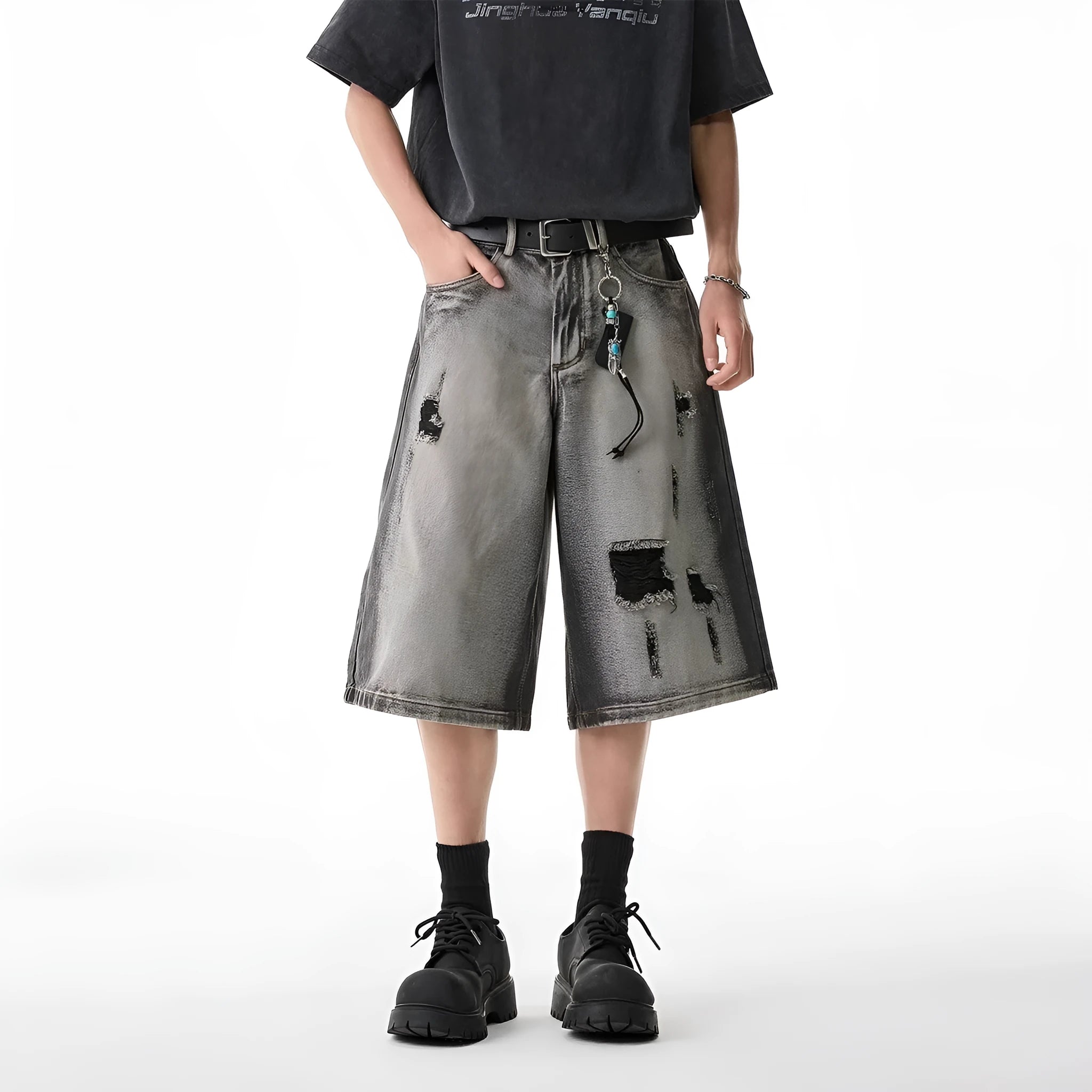 Grey denim shorts with loose fit and cropped length on hanger