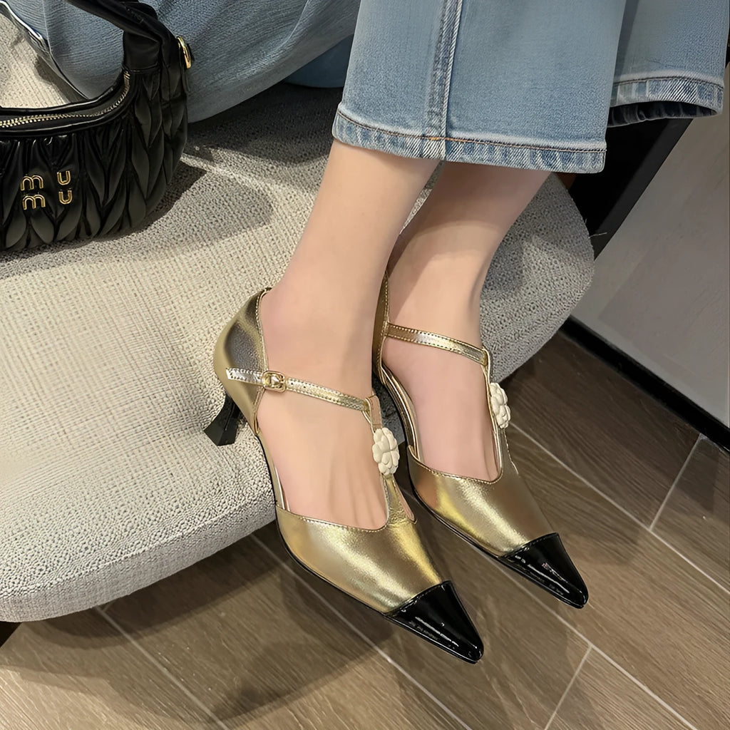 Women's gold stiletto shoe with flower decoration and buckle on a pointed toe goat leather upper.