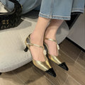 Women's gold stiletto shoe with flower decoration and buckle on a pointed toe goat leather upper.