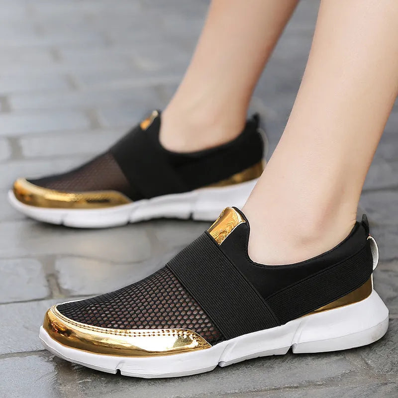 Women's low-top casual sneaker in grey with breathable mesh upper and lightweight sole.