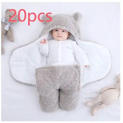 A baby quilted sleeping bag wrapper in a cotton blend fabric, shown in a light blue colour, laid flat.