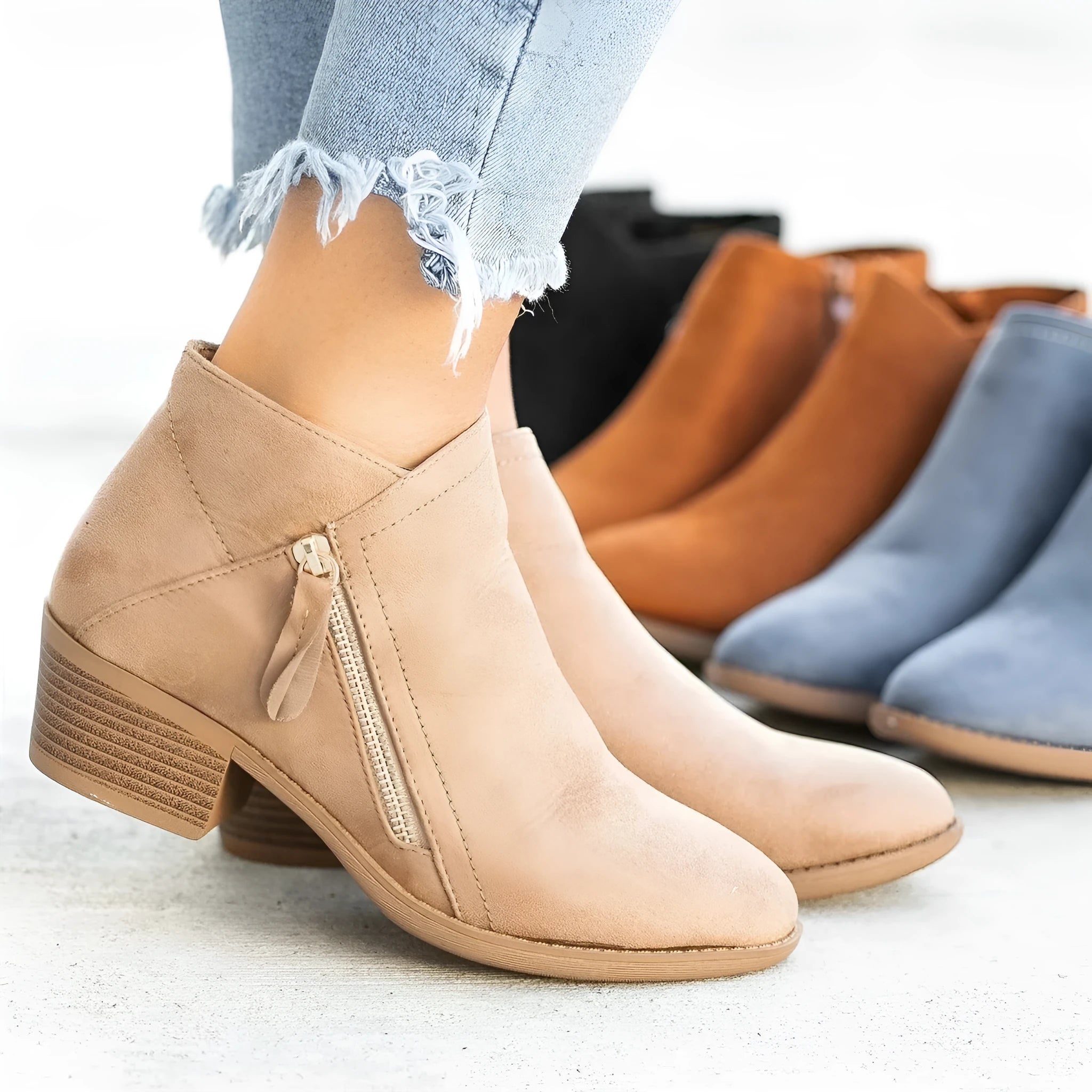 Women's suede ankle boots with chunky heel and side zip in beige, black, blue, or orange.