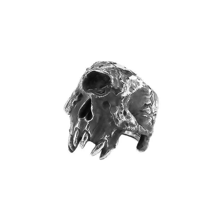Silver tone alloy ring featuring a detailed one-eyed skull design on a black background.