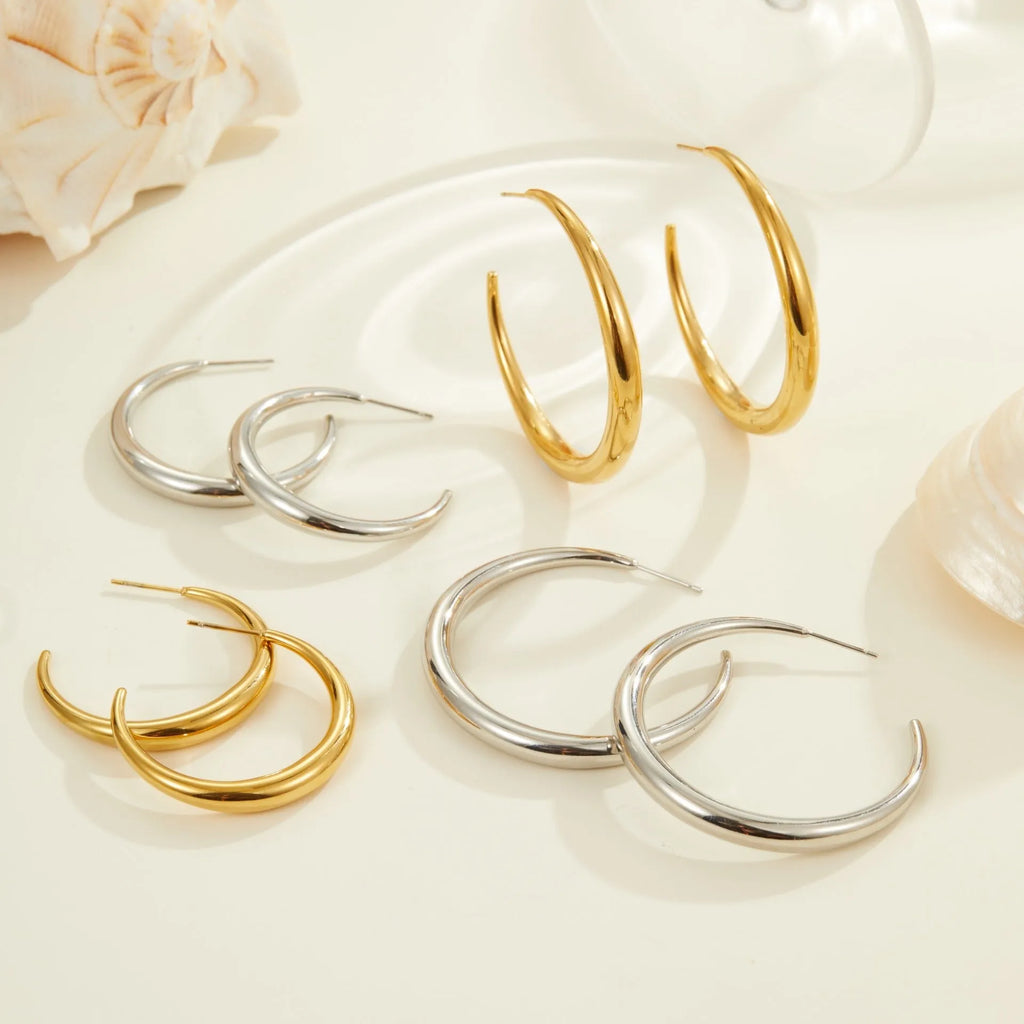 Titanium steel hoop earrings in geometric round design with gold or steel finishes