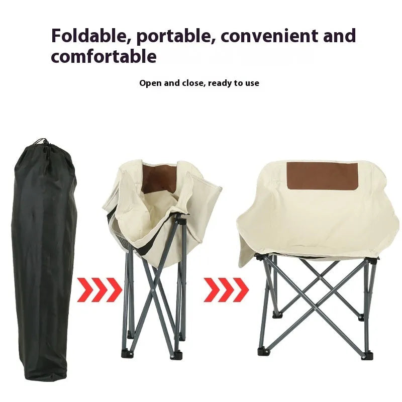 Beige portable folding camping chair with steel frame on grass outdoors