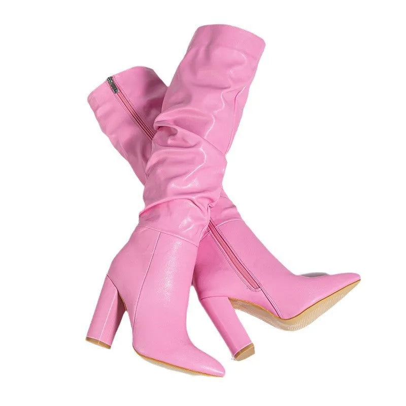 Women's white pointed toe high heel ankle boots with side zipper on a pink background