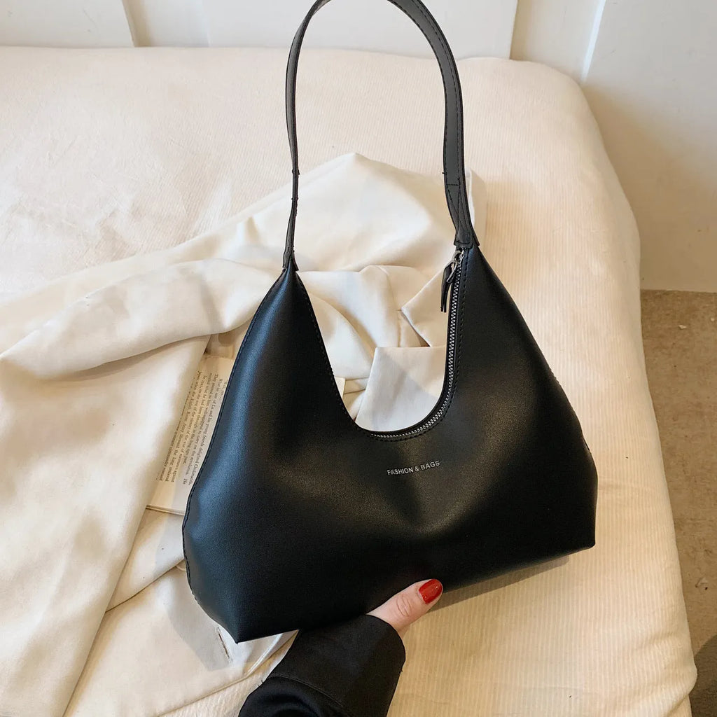 Women's retro style PU shoulder handbag in pillow shape with organised interior compartments