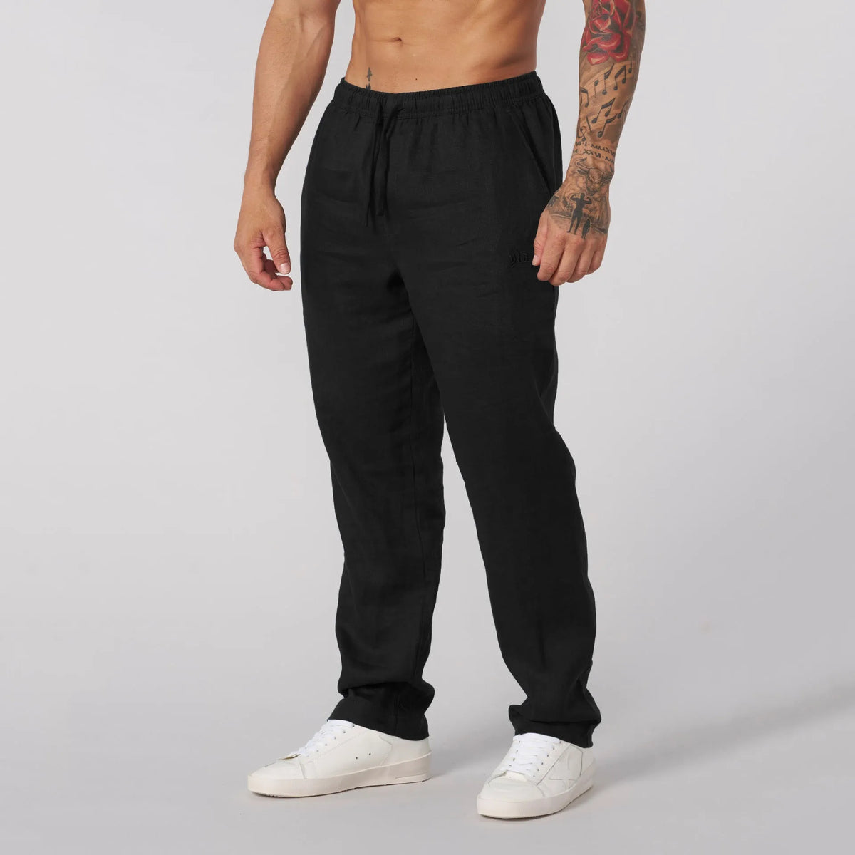 Men's casual sports trousers in polyester, available in white, black, khaki and sky blue, sizes S to XXL, no liner, regular length.