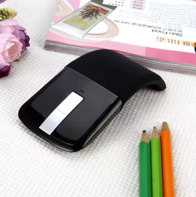 Folded Bluetooth wireless mouse showing compact size with touch surface and multiple colour options