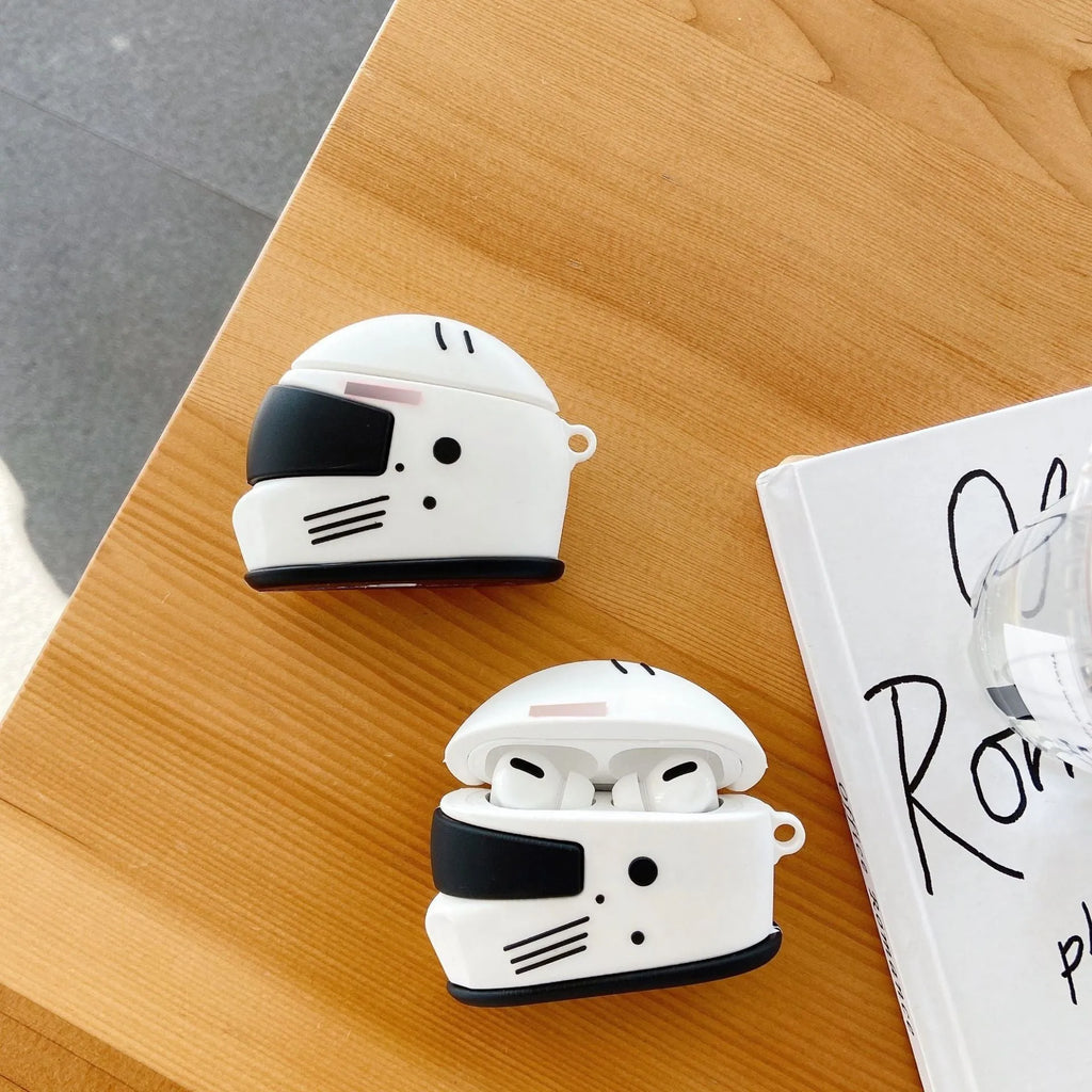 Black silicone AirPods case with motorcycle helmet shape, cartoon geometric design, and carabiner clip