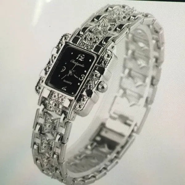 Women's square bracelet watch with black dial surface on display in OPP packaging