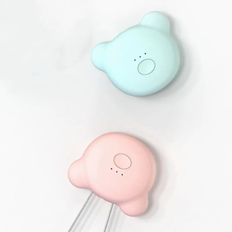 Small pink wearable USB air purifier necklace on a person, showing compact size.