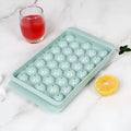 Blue silicone ice cube tray with lid showing 33 round grids for homemade ice