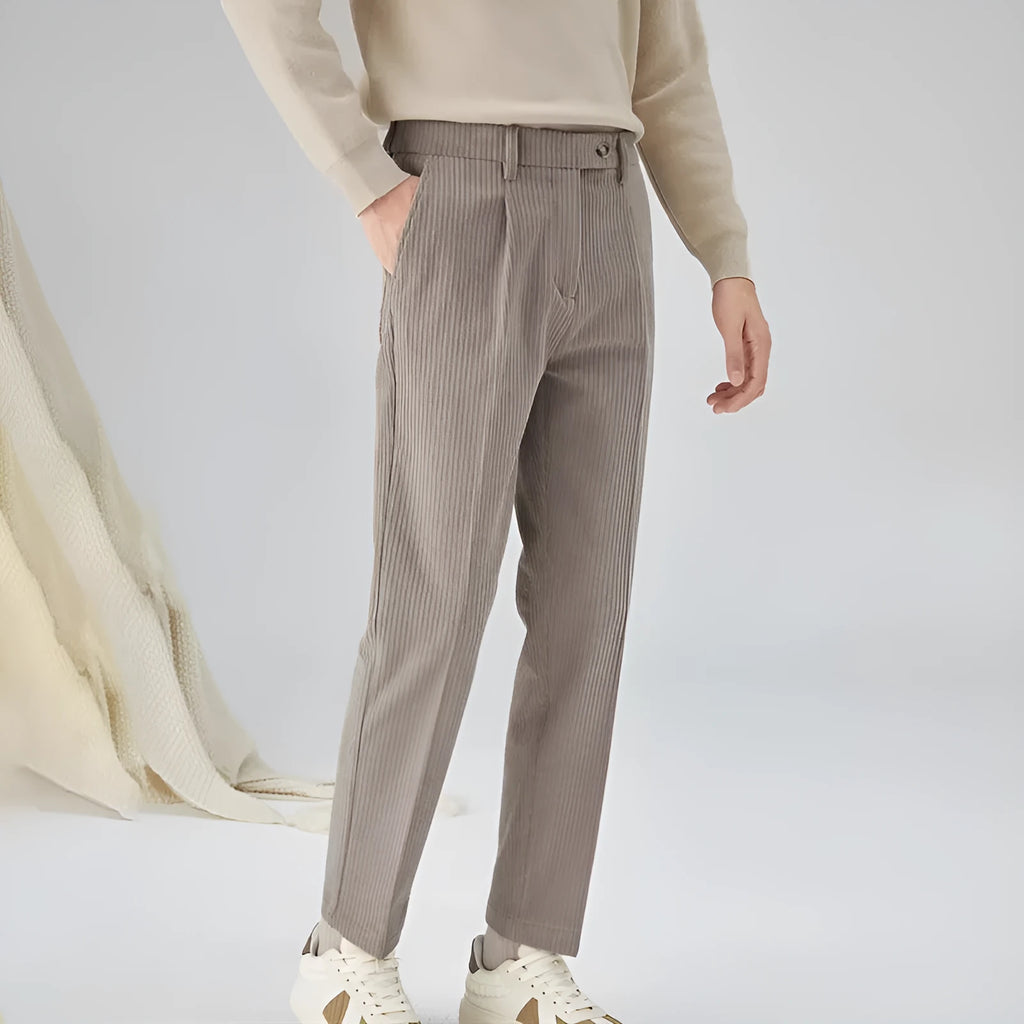 Men's straight-leg corduroy trousers in beige, shown laid flat to display the mid-waist and textured fabric.