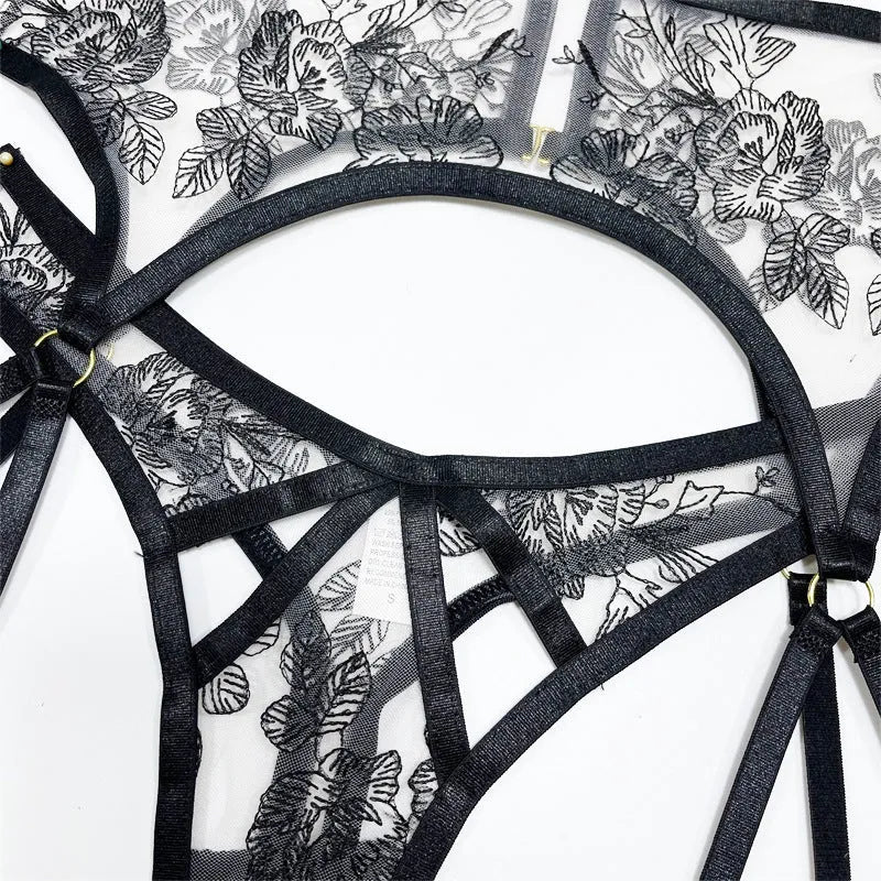 Black floral lace women's three-piece set with top, trousers, and waist cincher on a hanger.