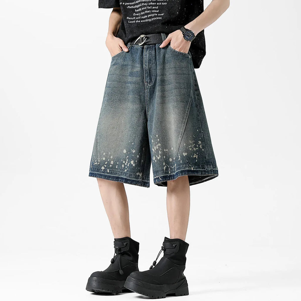 Men's retro blue denim shorts with ripped details and splash ink pattern