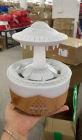 White UFO Raindrop Humidifier with 7-colour nightlight and essential oil diffuser on table