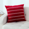 Square 45cm plush velvet pillow cover in wine red colour on a sofa.