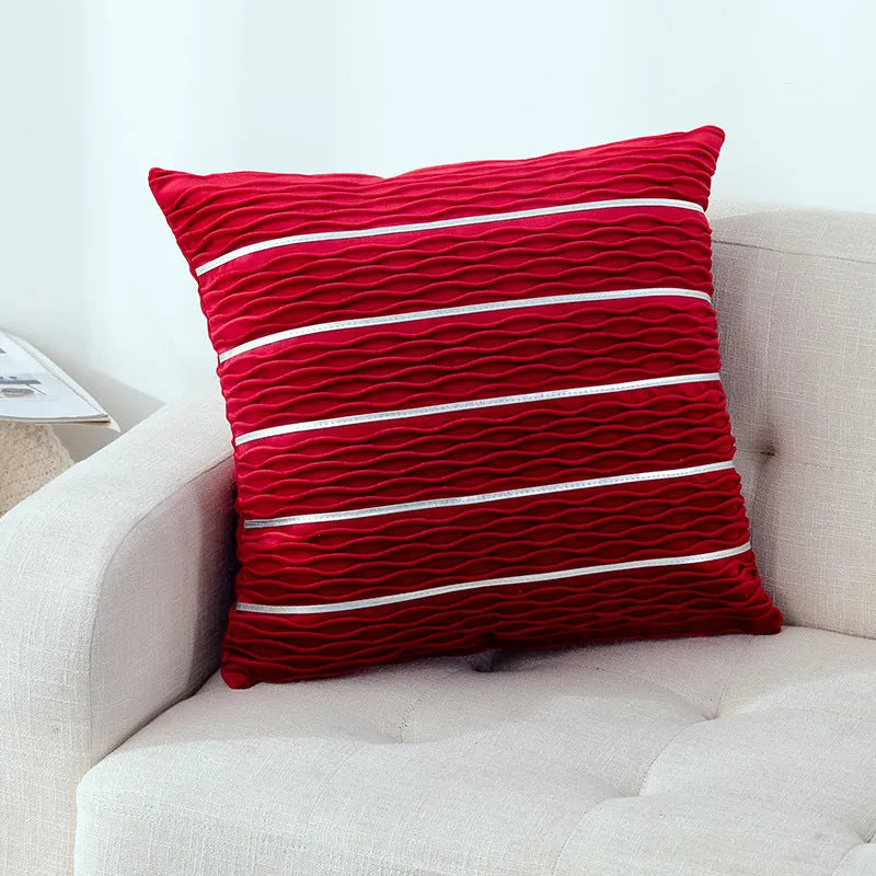 Square 45cm plush velvet pillow cover in wine red colour on a sofa.