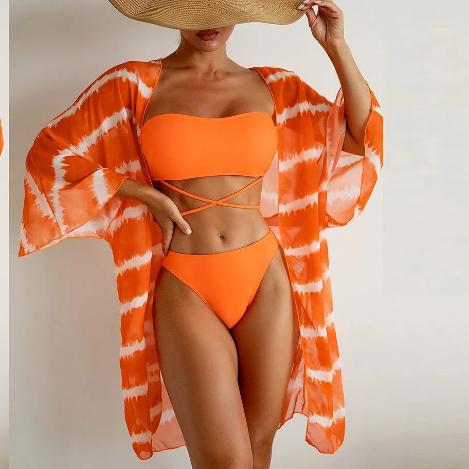Women's orange three piece swimsuit with nylon colour blocking fabric, bra, panties and cardigan.