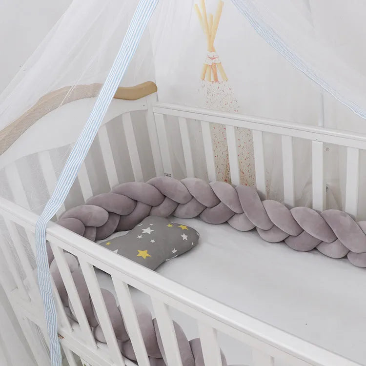 Baby crib bumper braid knot pillow cushion in spandex velvet fabric, shown in a multi-colour option.