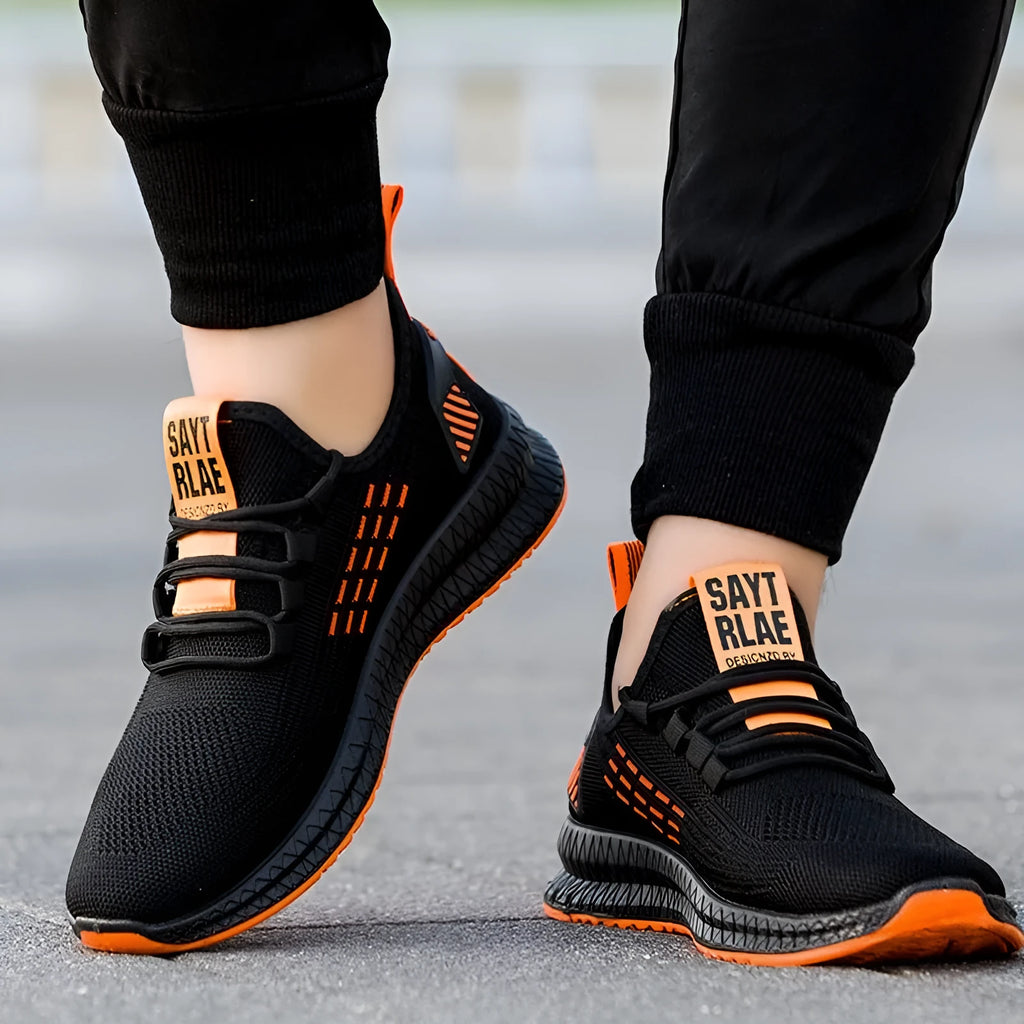 Men's black casual sports shoes with three white stripes and a cross strap on a breathable mesh upper.