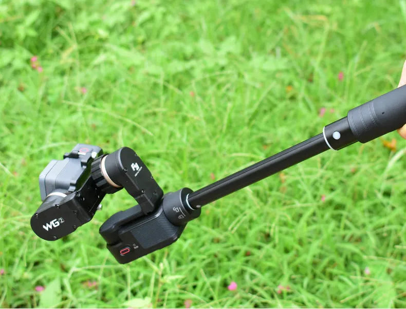 Black retractable aluminium selfie stick fully extended to 180cm with a smartphone attached.