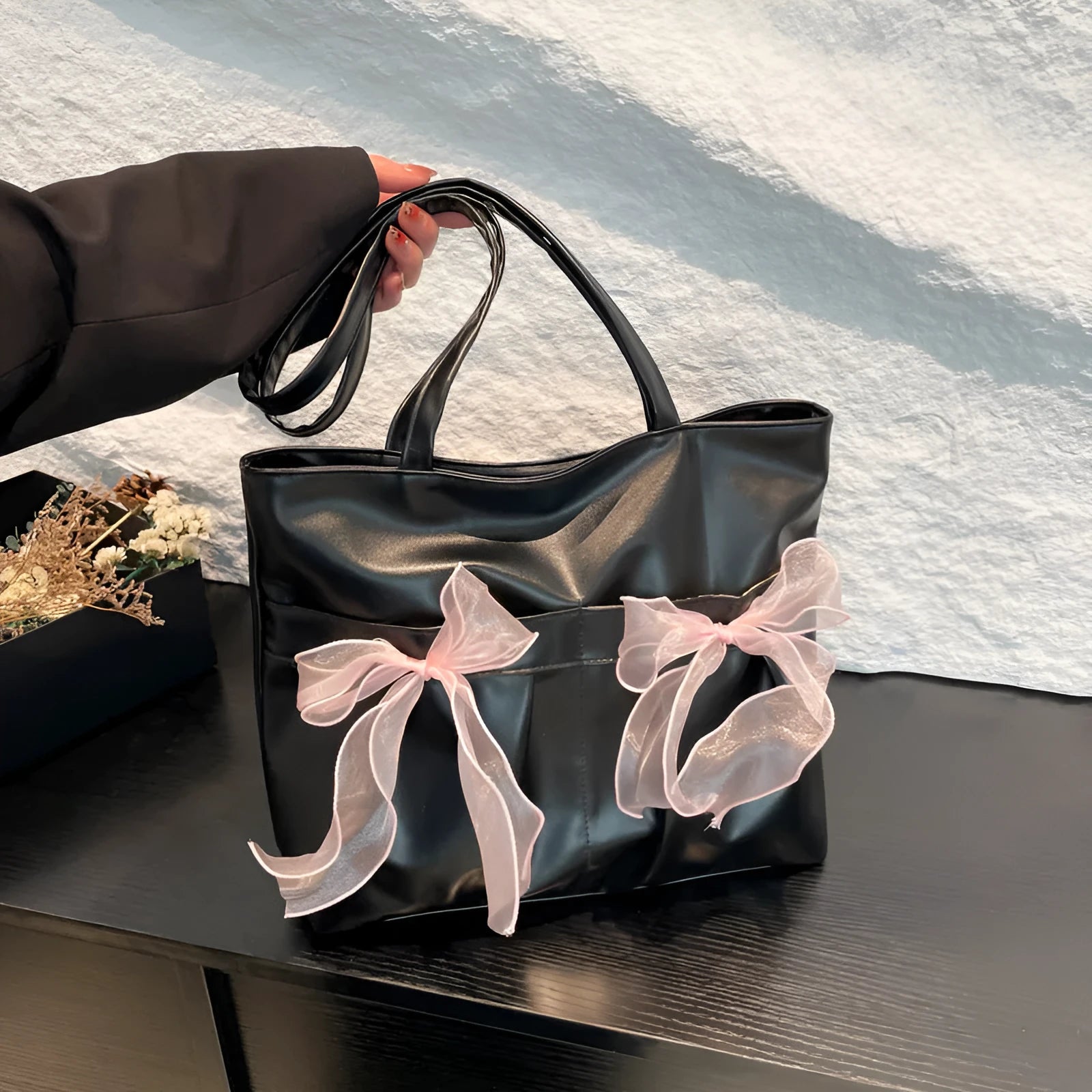College style bow tote bag in black with double shoulder straps and decorative bow