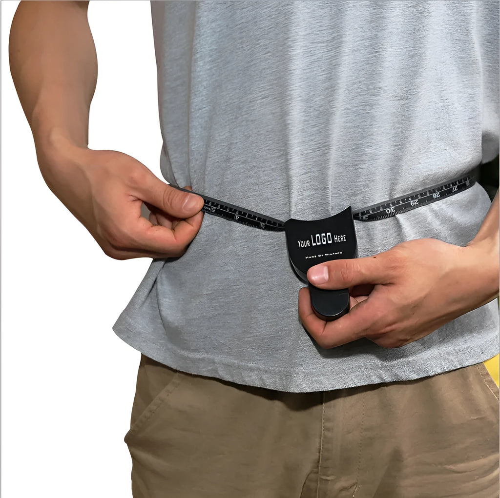 Black ABS plastic body fat caliper with measurement scale and included flexible measuring tape.