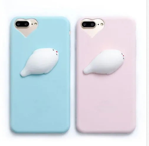 Soft pink silicone TPU phone case with a raised 3D cartoon cat design on the back, fitted to an iPhone.