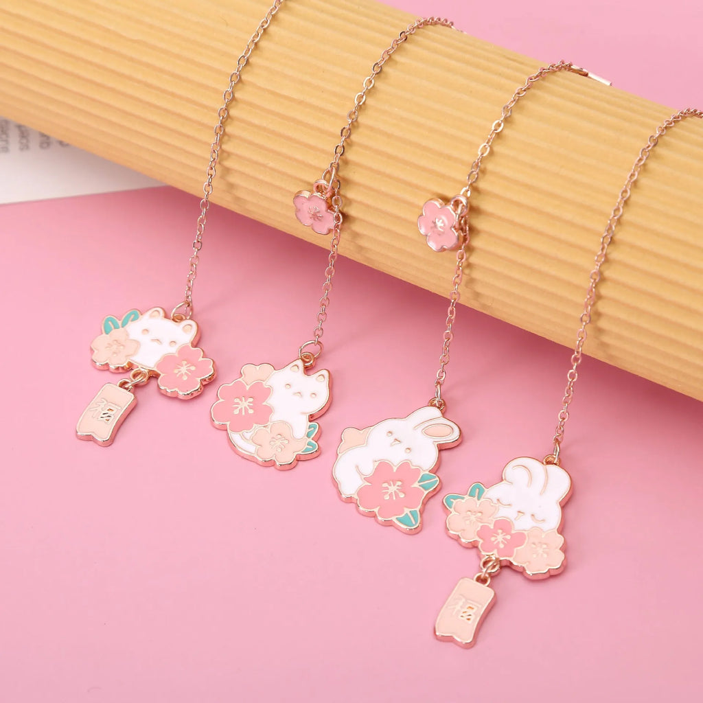 Metal book holder with pendant featuring cute cartoon cherry cat or rabbit sakura design