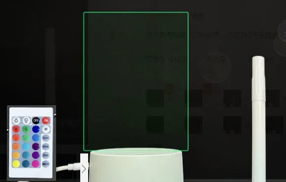 3D acrylic LED message board night light on a desk, showing illuminated surface and remote control