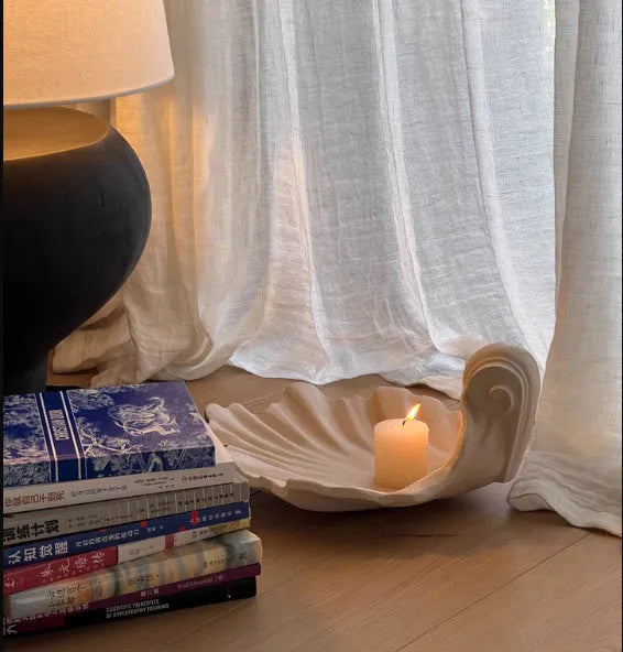 White resin fruit plate ornament with detailed simulation shell design on a table.