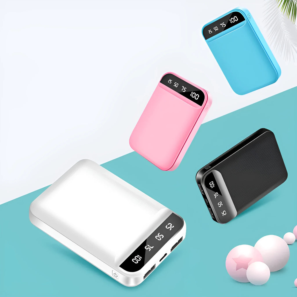 Compact mini power bank in black, blue, pink, or white, showing size compared to a hand.