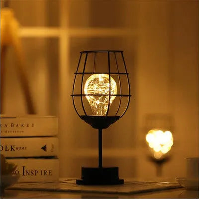 Minimalist hollow iron table lamp with warm white LED light in red wine bottle style