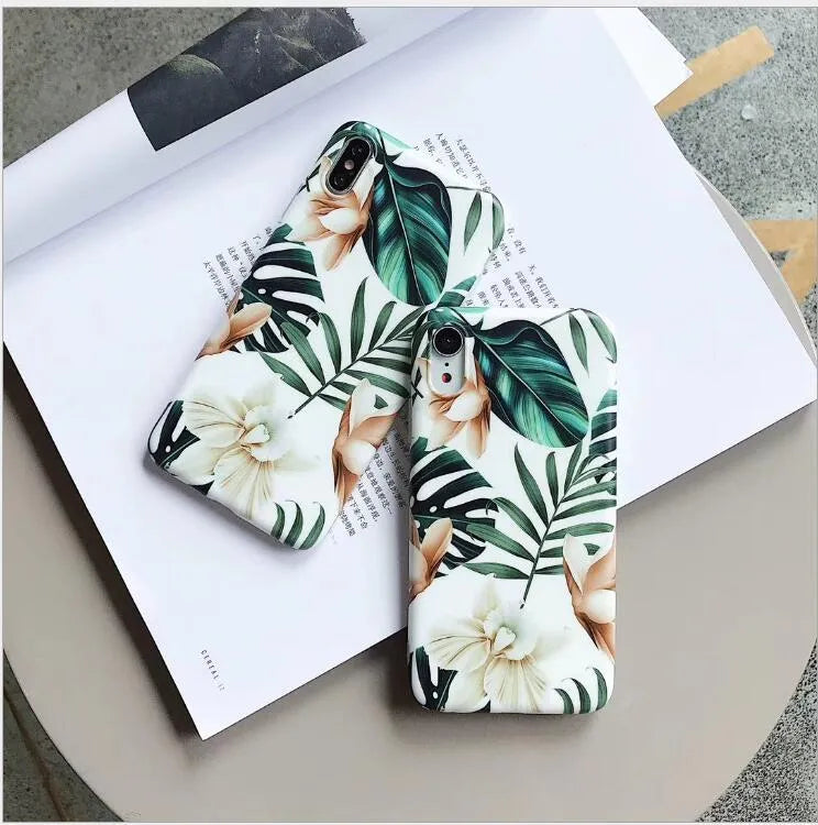 Soft TPU iPhone case with detailed floral and banana leaf art in green tones on the back.