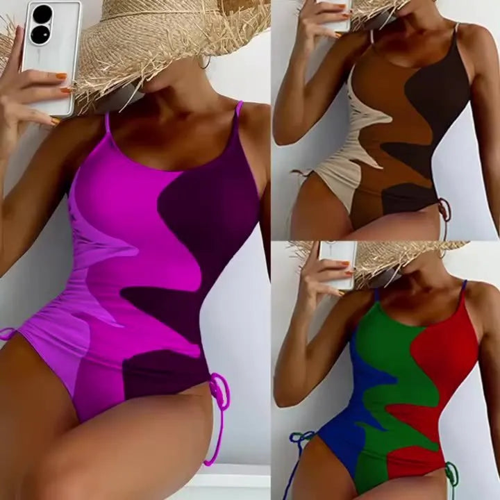 Women's blue sleeveless backless one-piece swimsuit on a hanger showing striped print detail.