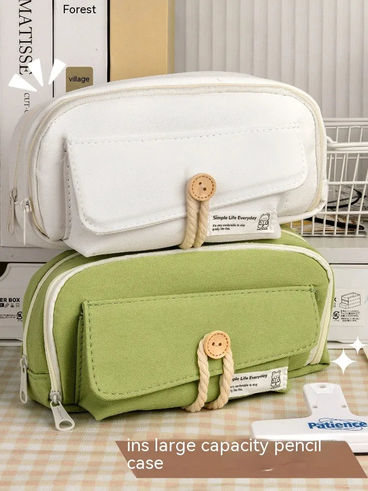 Girls canvas pencil case with button fastening showing large capacity for approximately 80 pens in beige colour