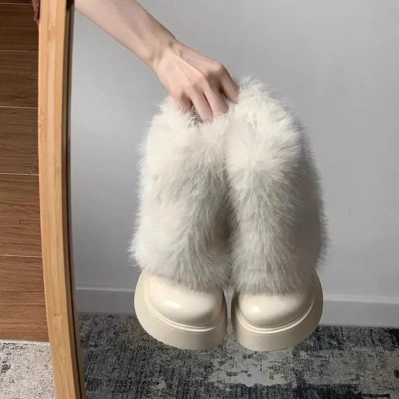 Women's black artificial plush snow boots with waterproof platform sole and low top design.