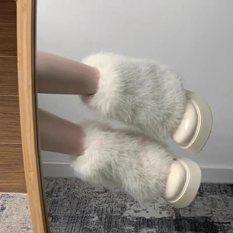 Women's black artificial plush snow boots with waterproof platform sole and low top design.