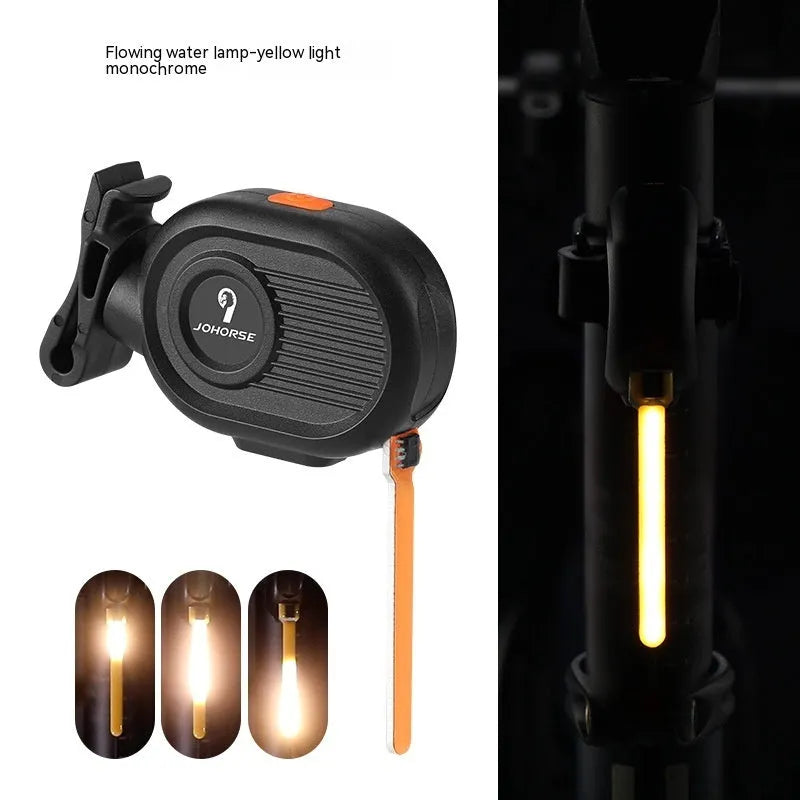 Blue waterfall effect bicycle tail light mounted on a bike seat post, showing dynamic LED light pattern.