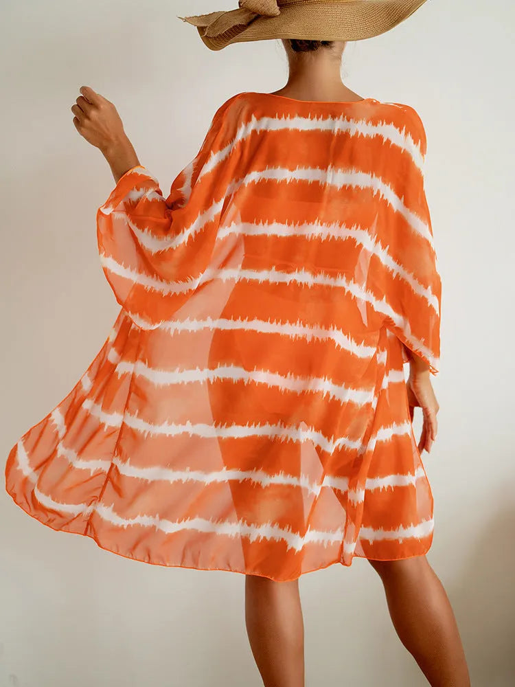 Women's orange three piece swimsuit with nylon colour blocking fabric, bra, panties and cardigan.