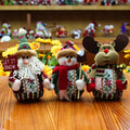 Set of red, green and white flannel Christmas decorations showing snowman, elk and old man designs