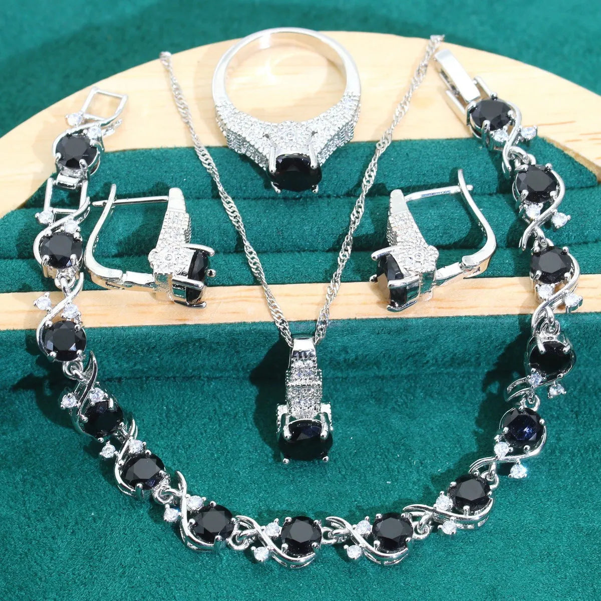 Four-piece bridal jewellery set with zircon alloy necklace, earrings, bracelet, and ring in water wave chain design